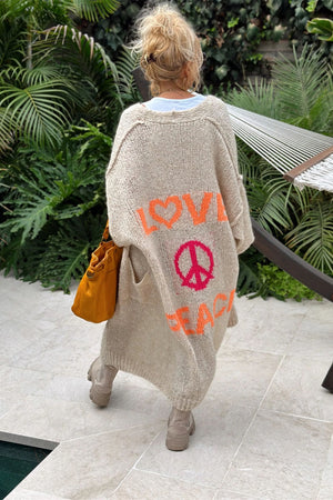 Khaki knit maxi cardigan with orange LOVE and pink PEACE sign graphic on back.