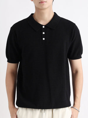 Black cotton short-sleeve polo shirt with button detail and textured knit