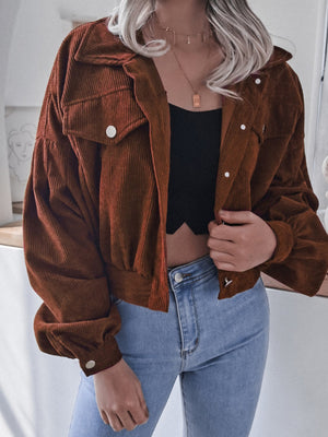 Brown corduroy cropped jacket with balloon sleeves and button-up front.