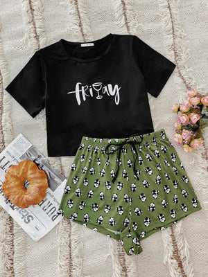 Black graphic tee with "friday" text and green panda print shorts.