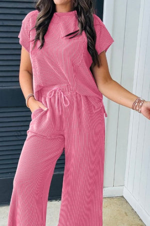 Fuchsia pink ribbed knit drawstring co-ord set with vertical stripes and short sleeves.