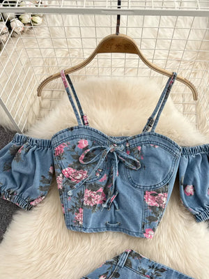 Denim sweetheart cami with floral print, tie front, and puff sleeves.