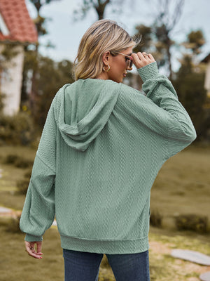 Sage green textured knit dolman sleeve hoodie with a hood and cuffed sleeves.