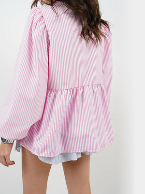 Pink and white striped peplum blouse with voluminous sleeves and tie front detail.