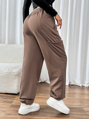 Taupe cargo joggers with elastic waistband and cuffs, and large side pockets.