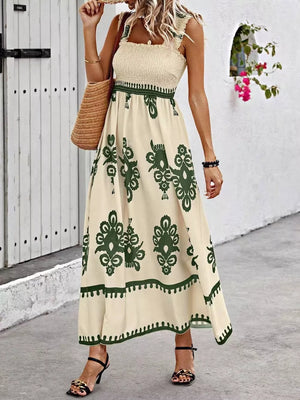 Smocked square neck maxi dress in tan with dark green paisley print and a-line cut.