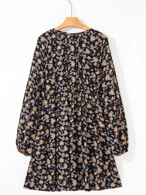Babydoll dress with dark floral print, bubble sleeves, and gathered waist.