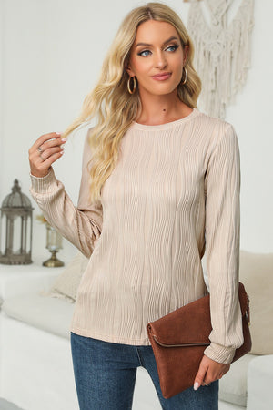 Textured wave crewneck pullover in blush pink with long sleeves and a relaxed fit.