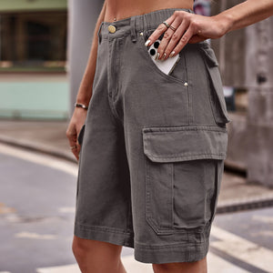 Dark gray denim cargo shorts with multiple pockets, phone in side pocket.