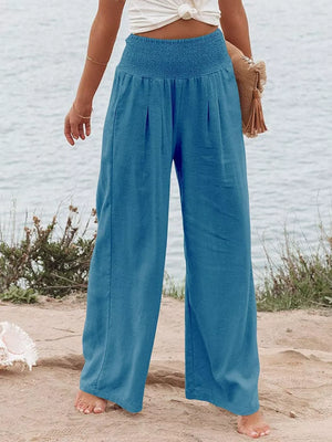 Sky Blue smocked maternity wide-leg pants with pleats and pockets.