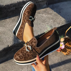 Brown leopard print wedge loafers with buckle detail and platform sole