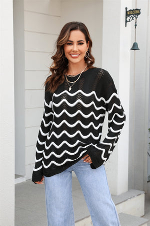 Black wavy knit openwork sweater with white wave pattern and crew neck.