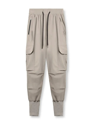 Technical cargo joggers in mocha with ribbed cuffs and zippered pockets.