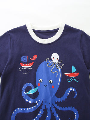 Navy cotton baby t-shirt with playful octopus and sailboat graphic, white trim neckline.