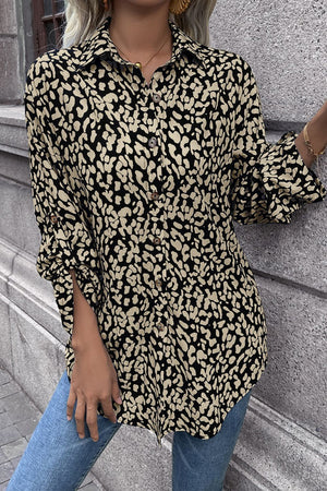 Women's black and beige abstract spot print oversized shirt with button front and rolled sleeves.