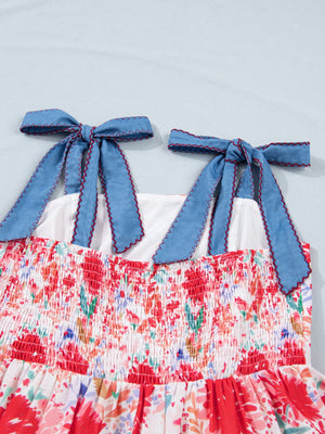 Floral print midi dress with smocked bodice and blue tie-shoulder straps.