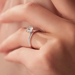 Sterling silver ring with a large moissanite center stone and pave band.