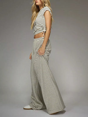 Off-white and black striped crop top with adjustable tie and wide-leg pants.