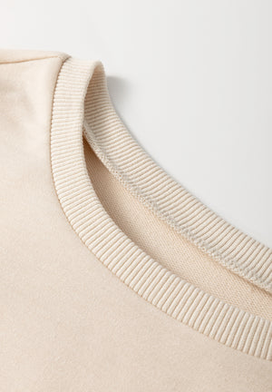 Beige knit tunic top with ribbed neckline detail