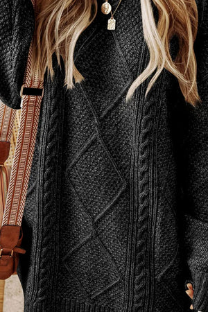 Black cable knit sweater dress with diamond pattern detail.