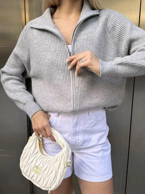Gray ribbed knit zipper cardigan with a stand-up collar and full zip closure.
