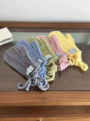 Cozy cable knit acrylic gloves in gray, blue, green, pink, and yellow with braided cuffs.
