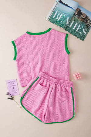 Pink cable knit loungewear set with green trim, sleeveless top and shorts.