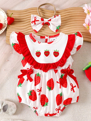 Baby cotton one-piece with strawberry print, red ruffles, and bow accents. Includes matching headband.