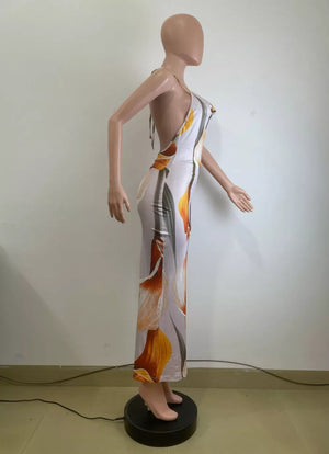 Maxi dress with cowl neck, backless design, and floral print.