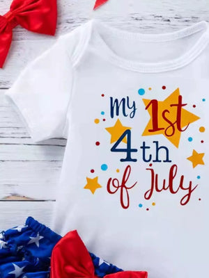 White baby onesie with "my 1st 4th of July" text and stars, paired with patriotic bloomer shorts and bow.