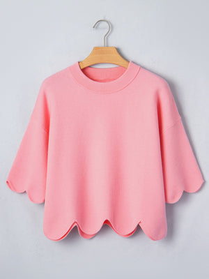 Pink knit top with scalloped hem and sleeves