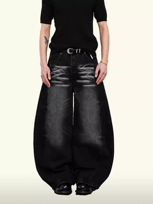 Belted wide leg denim jeans in black with a balloon silhouette and 100% cotton fabric.