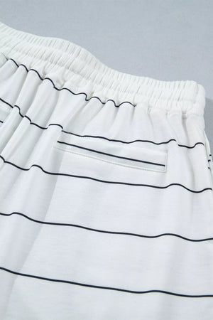 White polyester bikini shorts with black stripes and drawstring waist.