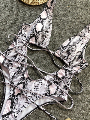 Snakeskin print one-piece swimsuit with plunging neckline and crisscross back ties.