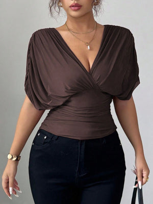 Brown ruched surplice dolman sleeve top with a deep V-neckline.