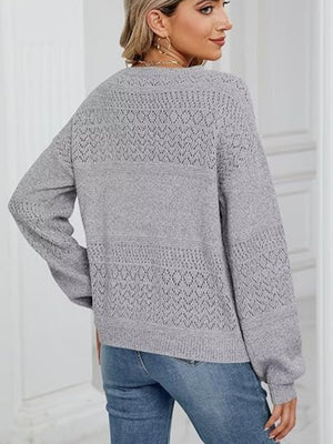 Light gray eyelet stitch V-neck pullover sweater with textured knit details.