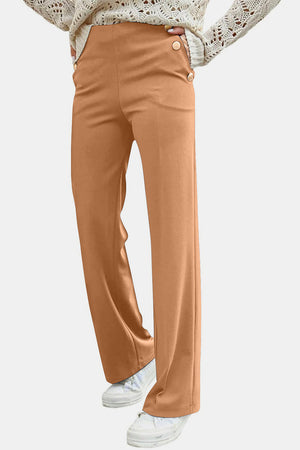Caramel wide leg trousers with button detail at the waist.