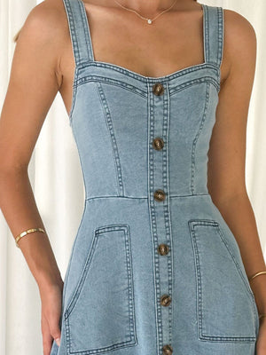 Light wash denim A-line dress with button front, square neckline, and patch pockets.
