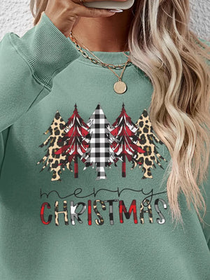 Sage green crewneck sweatshirt with Christmas trees in buffalo plaid, leopard, and red print and Merry Christmas text.
