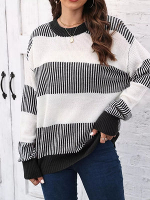 Cozy knit sweater with black and white stripes, crew neck, and ribbed cuffs.