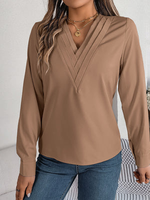 Camel V-neckline blouse with pleated detail and long sleeves.