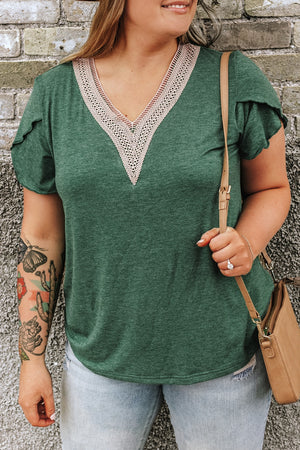 Dark green tee with lace trim V-neck and flutter sleeves, styled with light wash jeans.