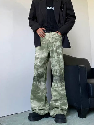 Abstract print wide-leg jeans in green with black graphic detail.