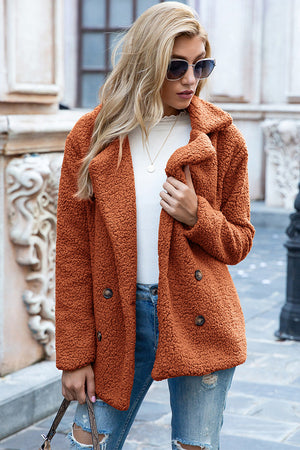 Teddy pea coat in burnt orange with double-breasted closure and button details.
