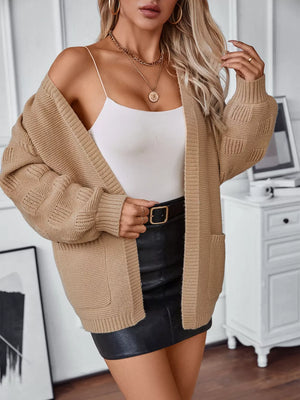 Chunky knit camel open-front cardigan with pockets and cable-knit sleeves.