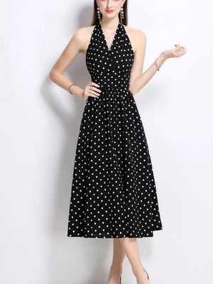 Black polka dot halter midi dress with a V-neck and gathered waist.