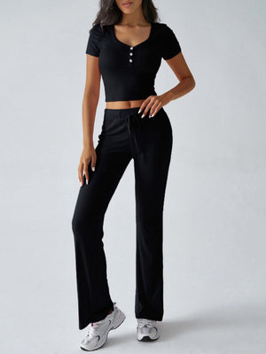 Black button-front crop top with short sleeves and drawstring flared pants.