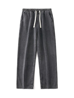 Relaxed wide-leg jeans in dark gray denim with a drawstring waist and pockets.
