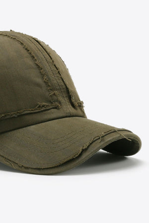 Army green denim baseball cap with raw edge details and distressed stitching.