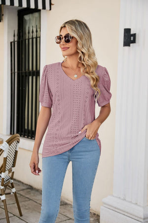 Perforated puff sleeve V-neck blouse in blush pink with eyelet details.